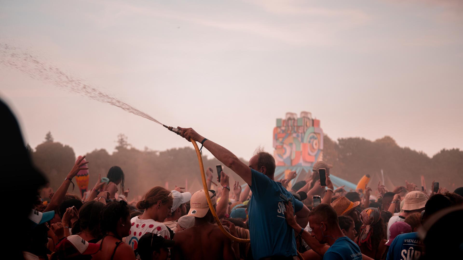 A photo of people spraying each other with water at a festival. By Mat Napo.