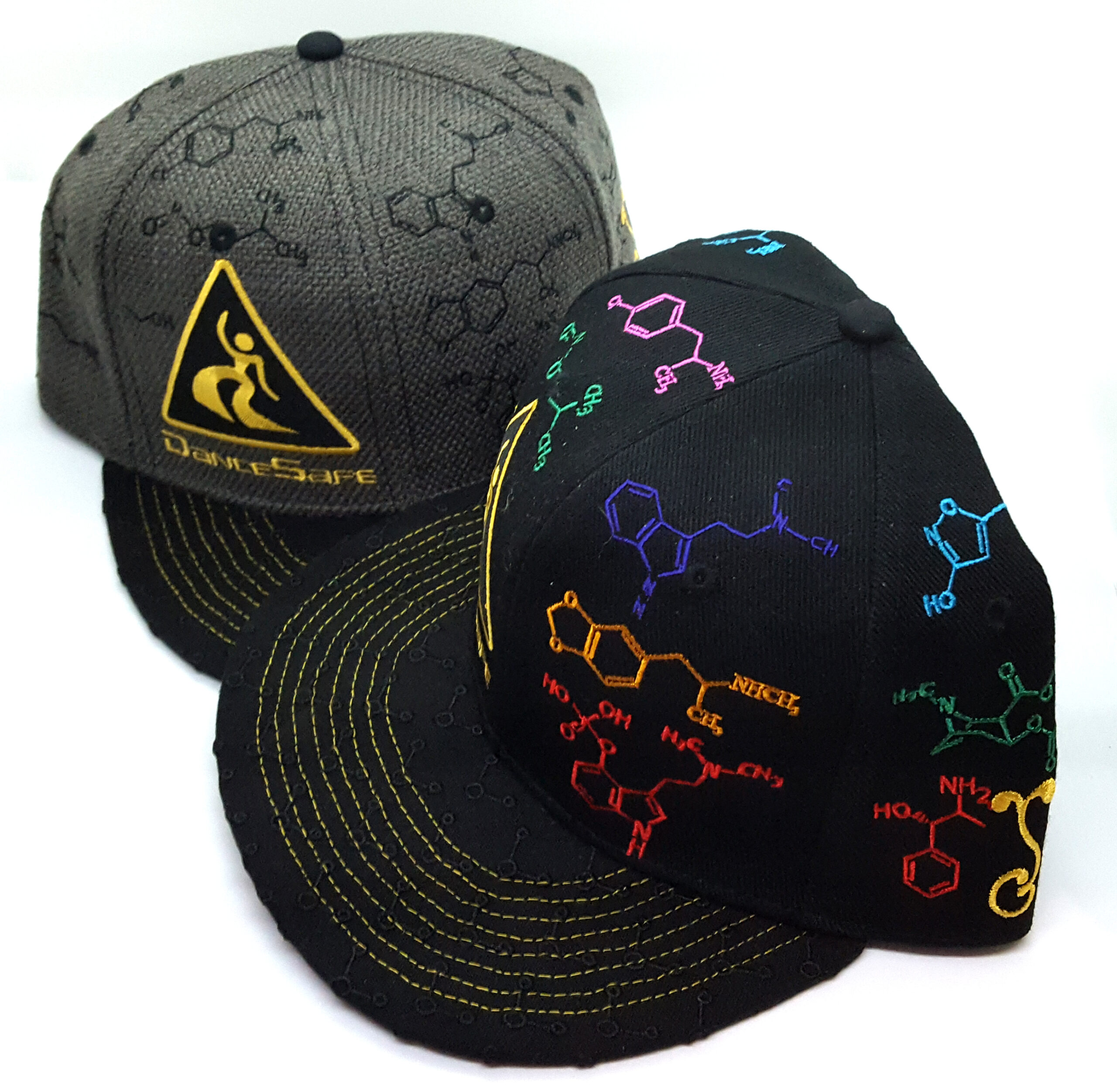 Two grey baseball caps with drug molecules and the old DanceSafe logo on them.