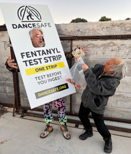 A photo of Emanuel, DanceSafe's founder, and his partner Jill dressed up as a fentanyl test strip and fentanyl dealer for Halloween.